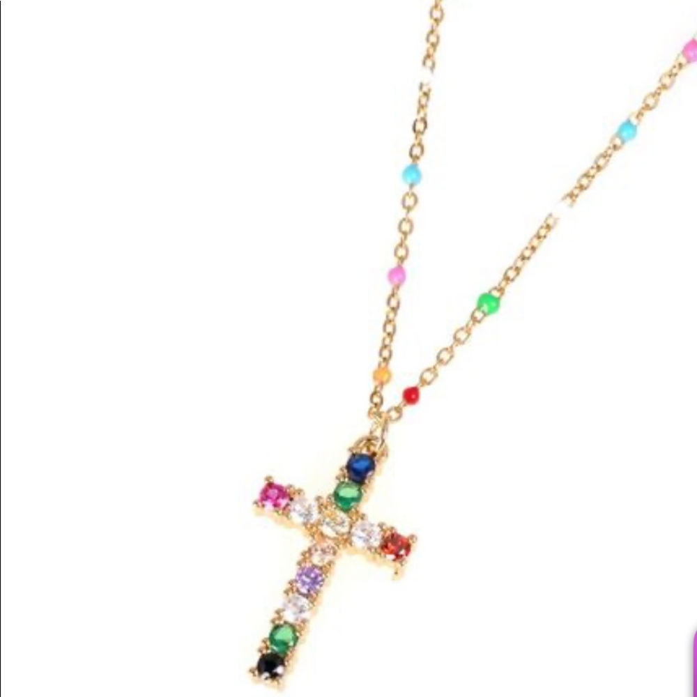 Gold tone cross necklace with colored stones.